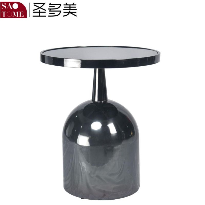 a Small Black Glass End Table That Can Be Placed Next to The Sofa